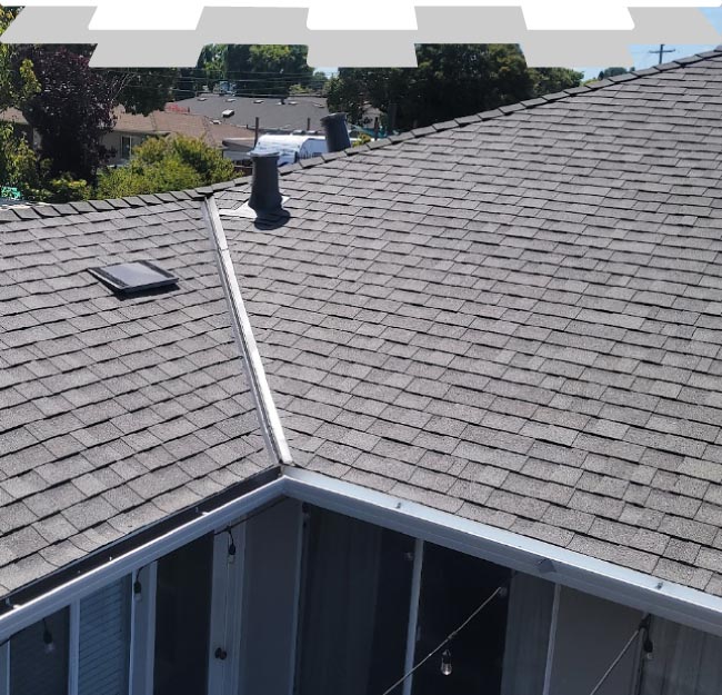 A flawlessly installed dark grey architectural asphalt shingle roof by New Concept Roofing Inc., showcasing perfect alignment, clean valley integration, and elegant residential curb appeal