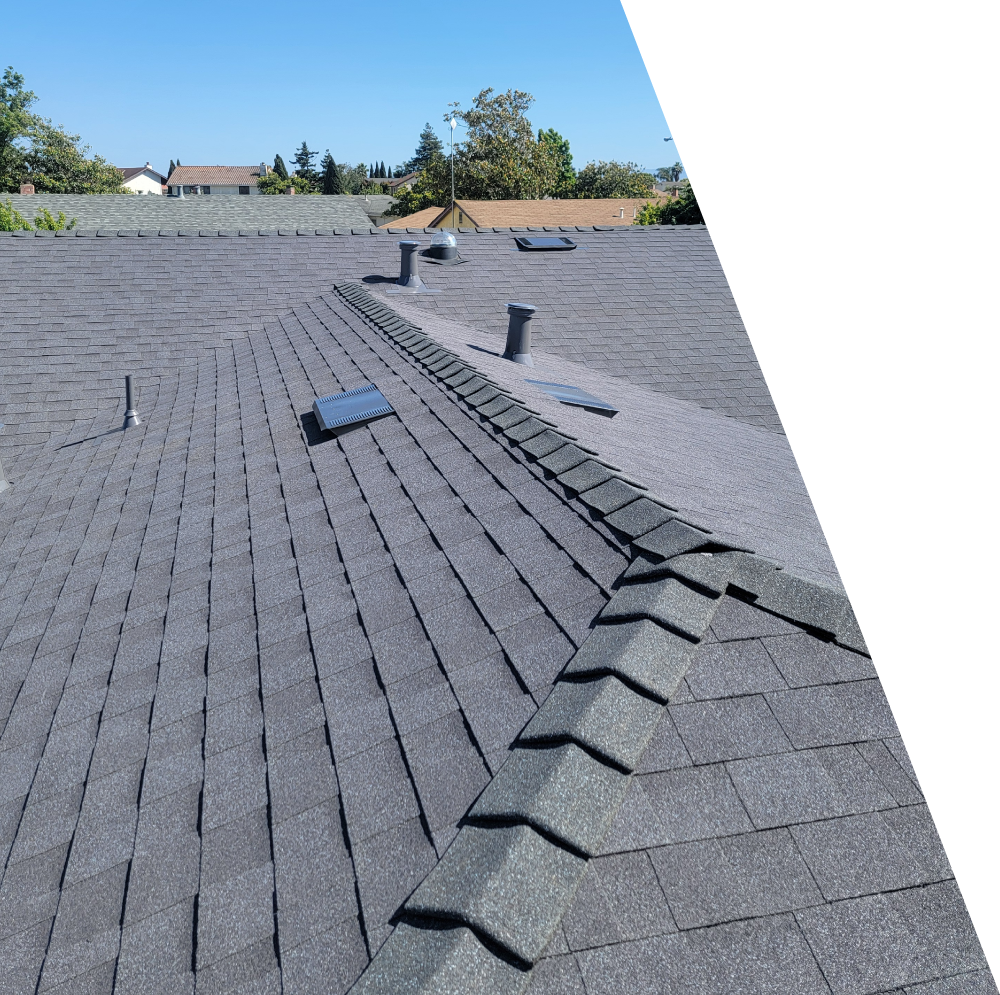 A flawlessly completed residential architectural asphalt shingle roof installation by New Concept Roofing Inc., highlighting clean ridge caps, integrated skylights, and premium dark charcoal grey shingles under a clear blue sky.