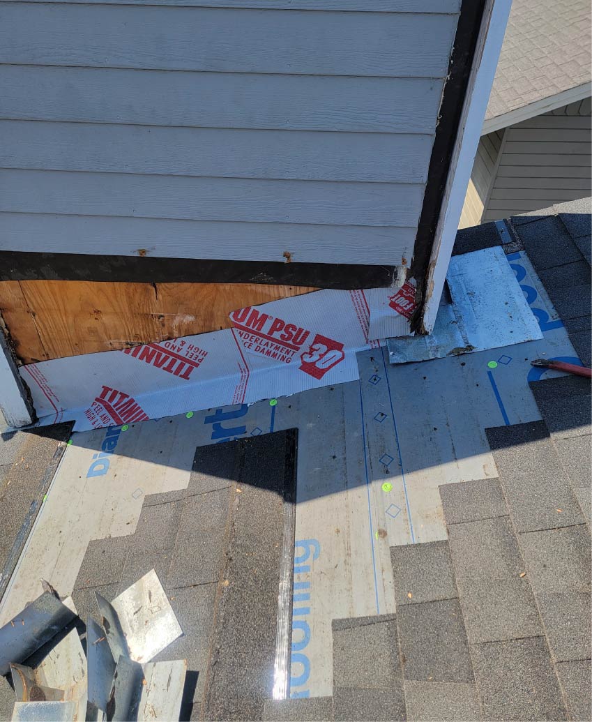 Close-up view of premium dark gray architectural asphalt shingles being hand-nailed and aligned during a professional roofing service by New Concept Roofing Inc.