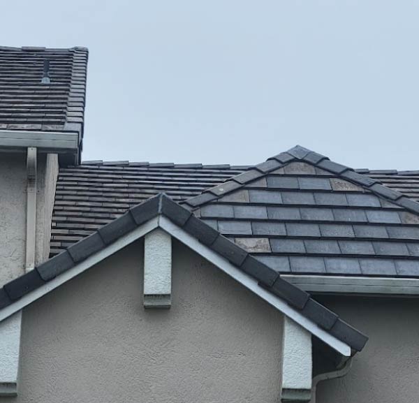 A detailed, close-up shot of a newly installed terracotta Spanish tile roofing system by New Concept Roofing Inc., highlighting the uniform pattern and durable interlocking design.