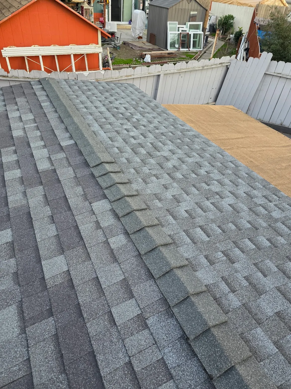Completed asphalt shingle roof replacement with new ridge cap by New Concept Roofing Inc.