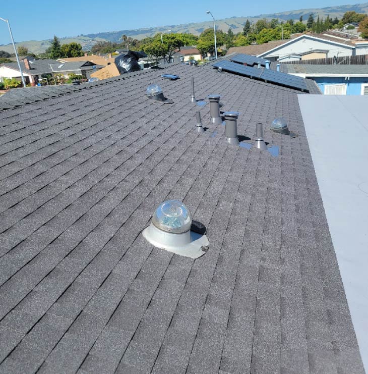 Architectural shingle roof installation with roof vents and skylight dome in San Jose, CA by New Concept Roofing Inc.