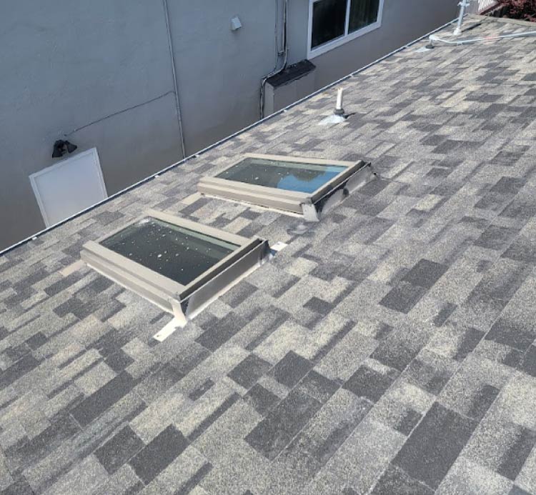 Asphalt shingle roofing with flat skylights installed in San Jose, CA by New Concept Roofing Inc.